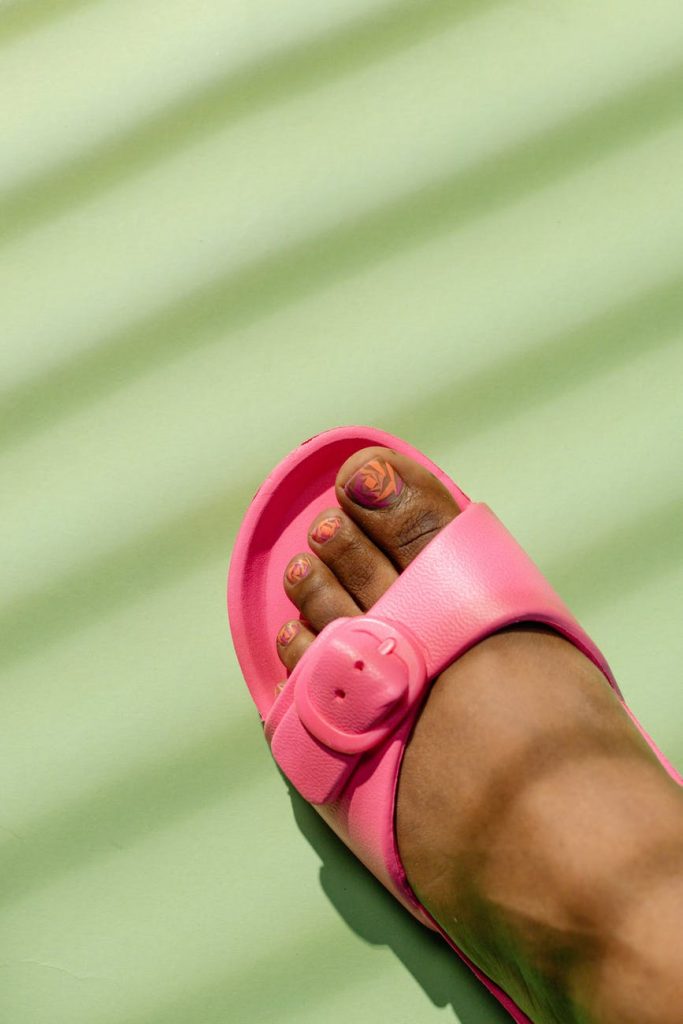 person wearing pink slide sandals