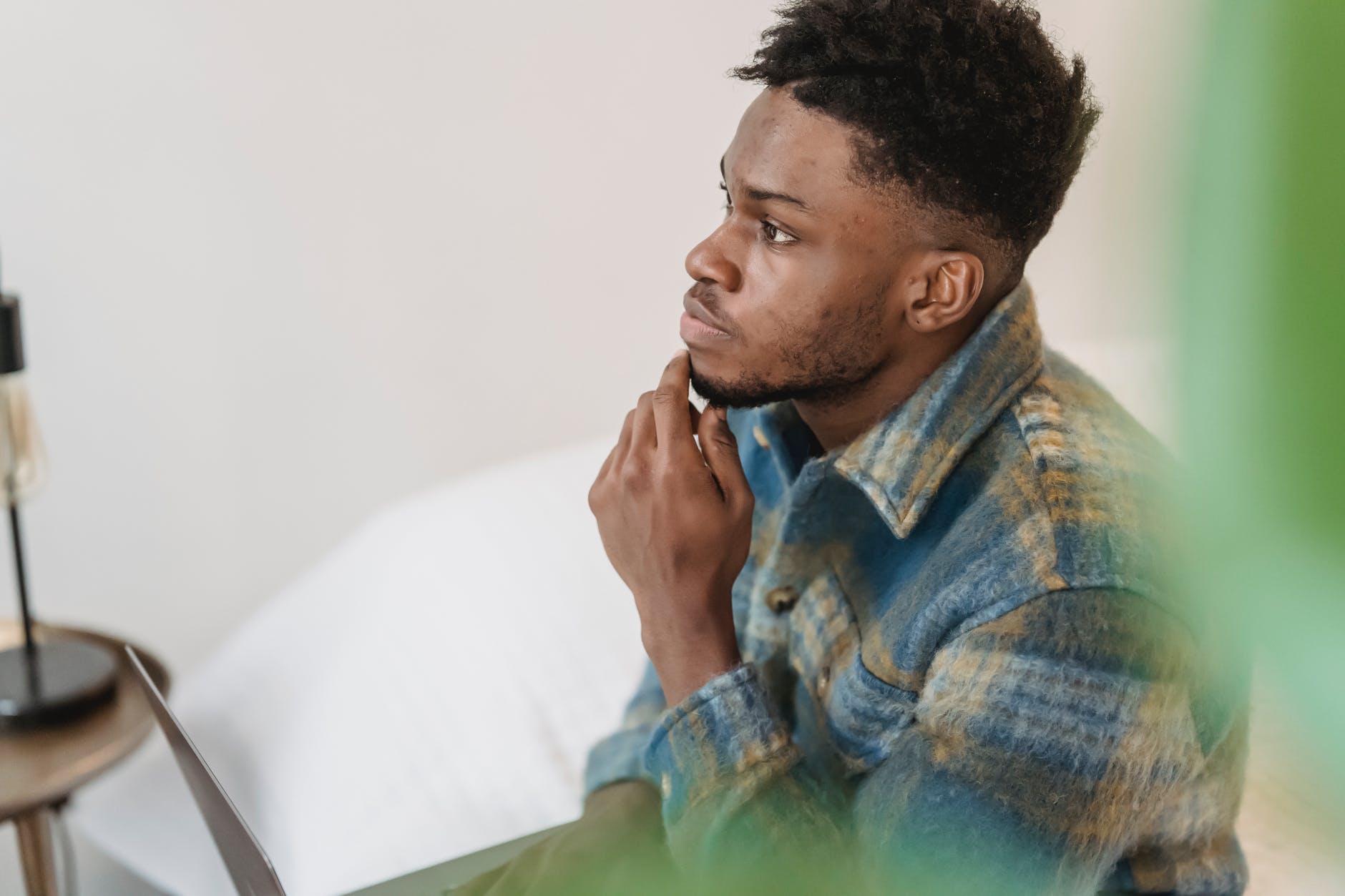 pensive black man thinking in light room